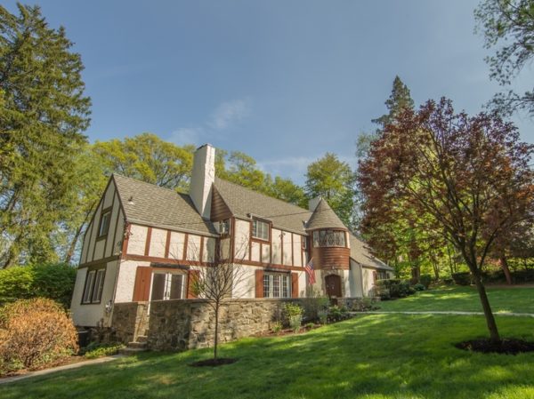 exterior of tudor home for sale at maltz auctions in new york