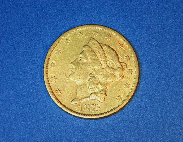 golden coin on blue surface for sale by maltz auctions in new york