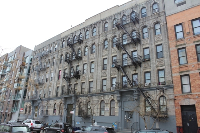 exterior of apartment building for sale at maltz auctions in new york