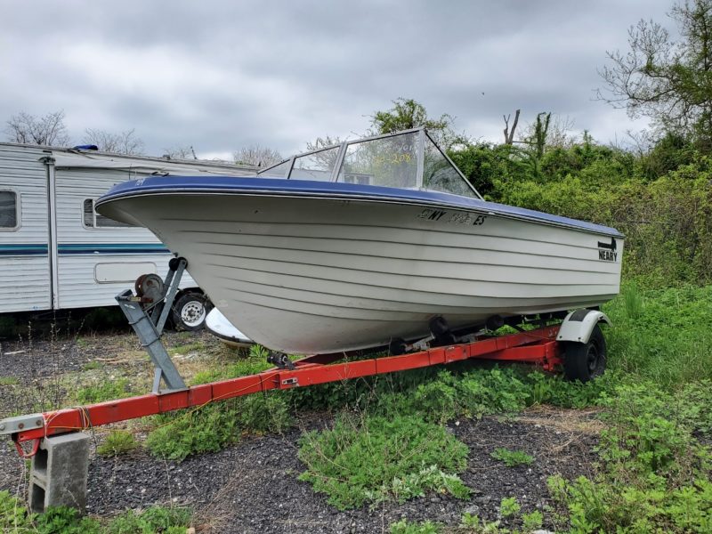 white and blue boat for sale at maltz auctions in new york