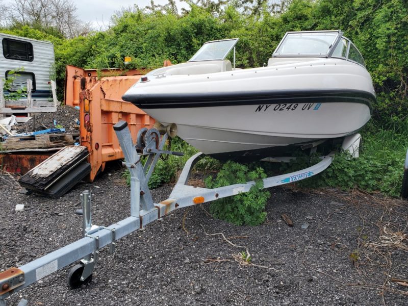 white boat on trailer for sale at maltz auctions in new york