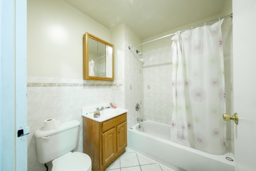 bathroom of 16-unit multifamily building for sale at maltz auctions in new york