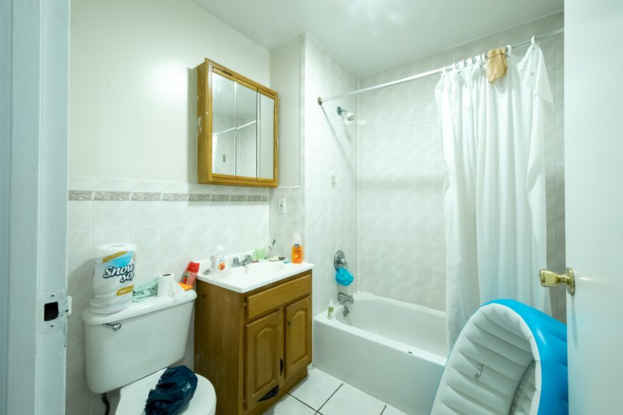 bathroom of 16-unit multifamily building for sale at maltz auctions in new york