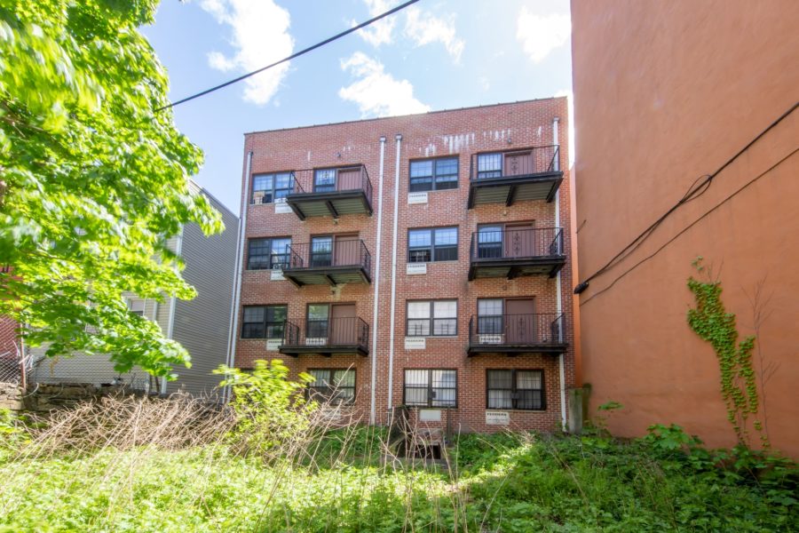 outside of 16-unit multifamily building for sale at maltz auctions in new york