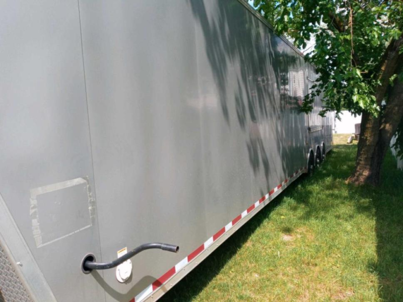 outside side view of millenium trailer up for sale at maltz auctions in new york city