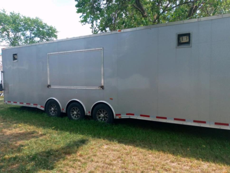 outside side view of millenium trailer up for sale at maltz auctions in new york city