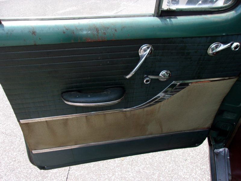 Inside view of front driver's side door of old Pontiac car up for auction