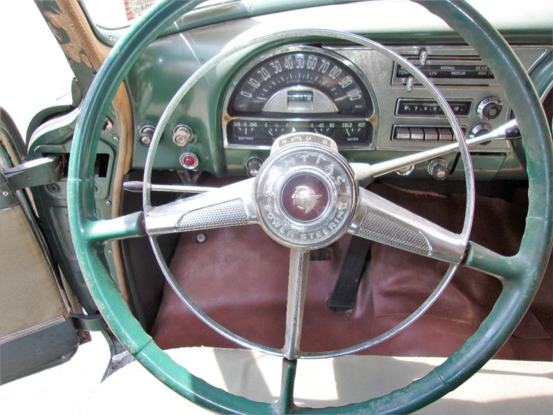 View of steering wheel of old Pontiac up for auction at Maltz Auctions