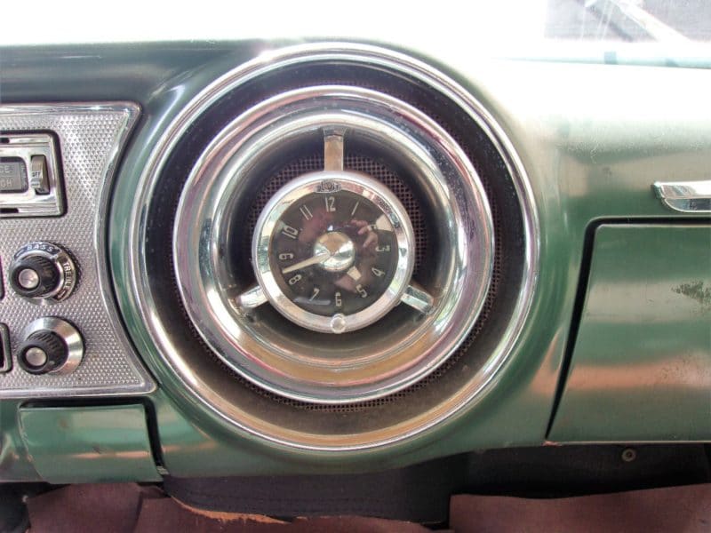View of old speedometer inside dated Pontiac up for auction