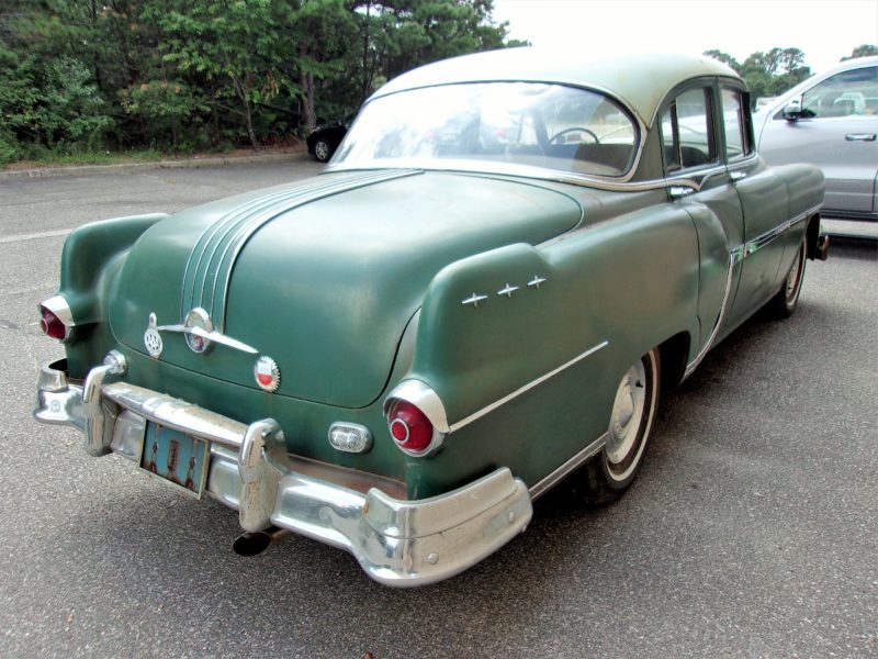Angled rearview view of old Pontiac car up for auction at Maltz Auctions
