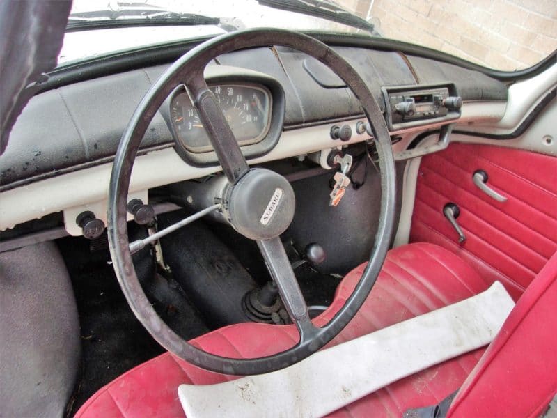 Close up of steering wheel and dashboard on Subaru automobile up for auction at Maltz Auctions