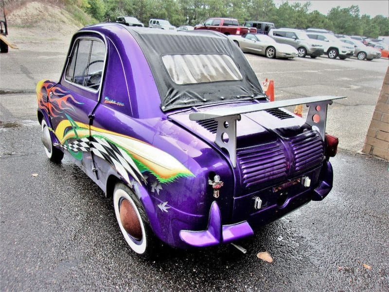 Angled back view of purple flamed automobile - buy at Maltz Auctions