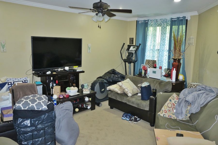 TV and futons in living area of home up for sale at Maltz Auctions