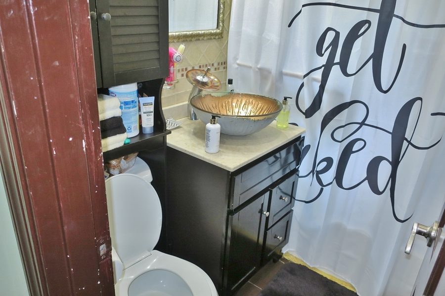 toilet and vanity in bathroom of home up for sale at Maltz Auctions