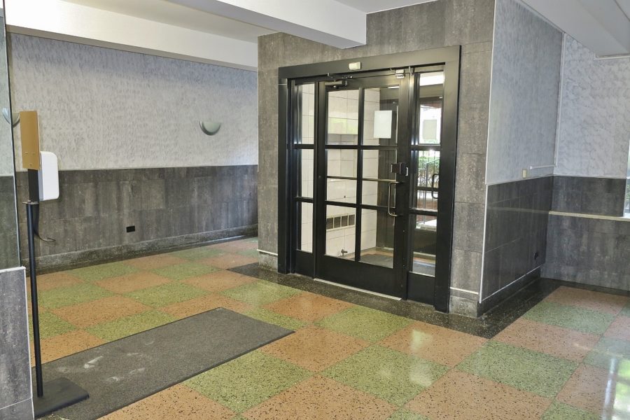 entrance doors of apartment complex with room for sale