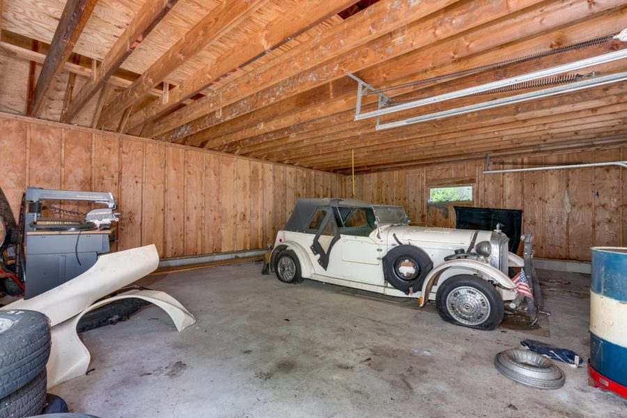 old car in garage on property for sale