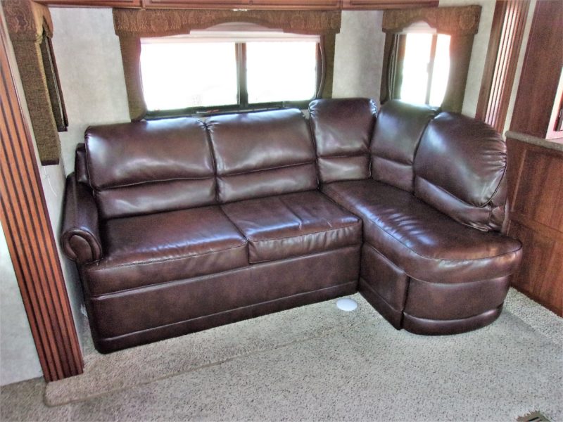Couch in the living room of camper automobile up for auction - find and buy private vehicles at Maltz Auctions