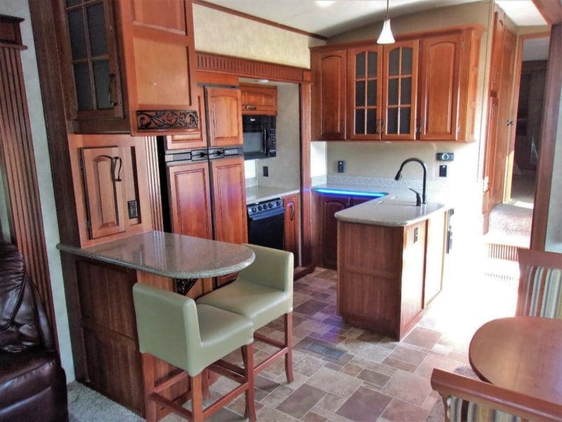 Kitchen and dining area in camper automobile up for auction - find more private vehicles up for sale at Maltz Auctions