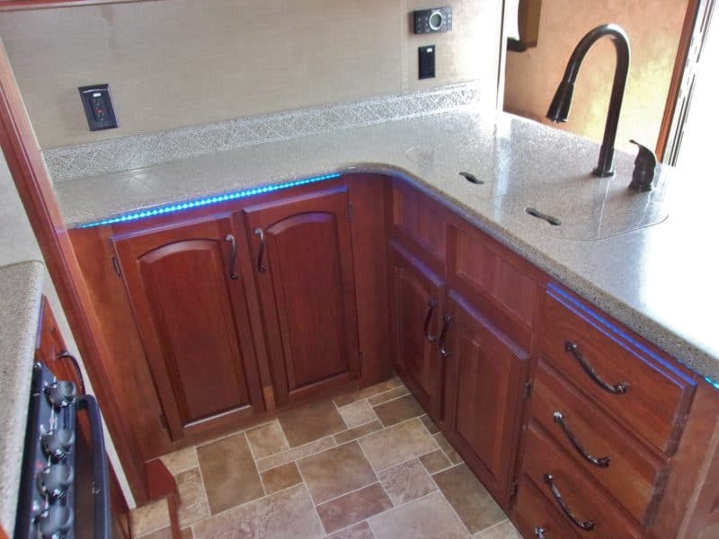 Sink and kitchen area in travel RV automobile - find more vehicles for sale at Maltz Auctions