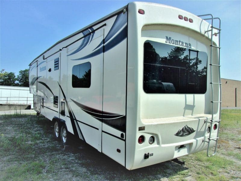 Angled back view of Montana camper up for auction at Maltz Auctions in New York - find more private vehicles up for sale
