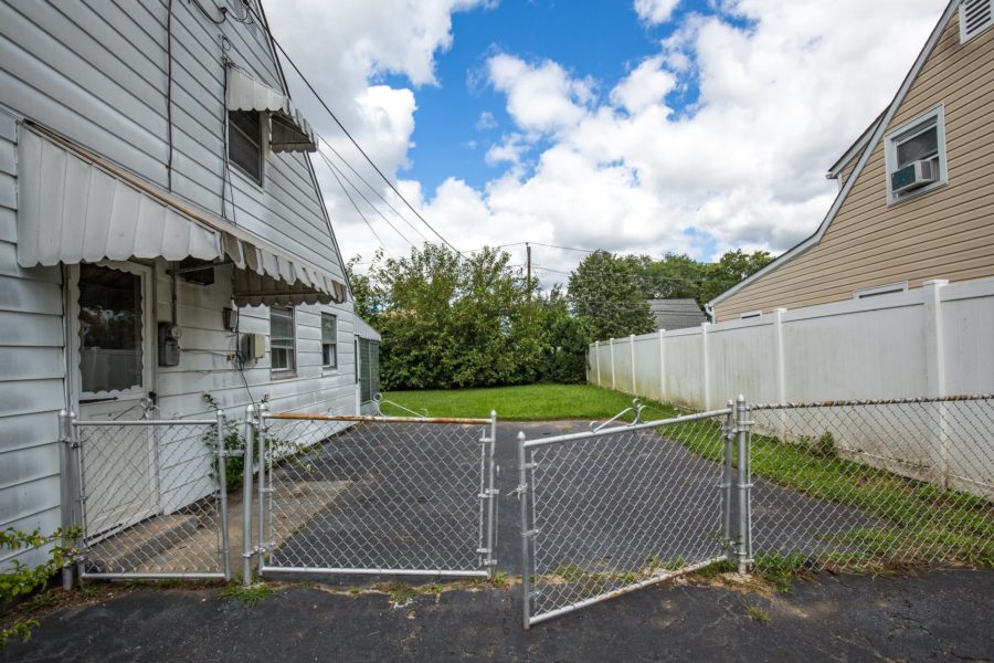 side yard of home for sale at Maltz Auctions